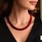 Crimson Noir Kumihimo necklace worn on model, handmade red and black beaded necklace by Bead & Braid Collective